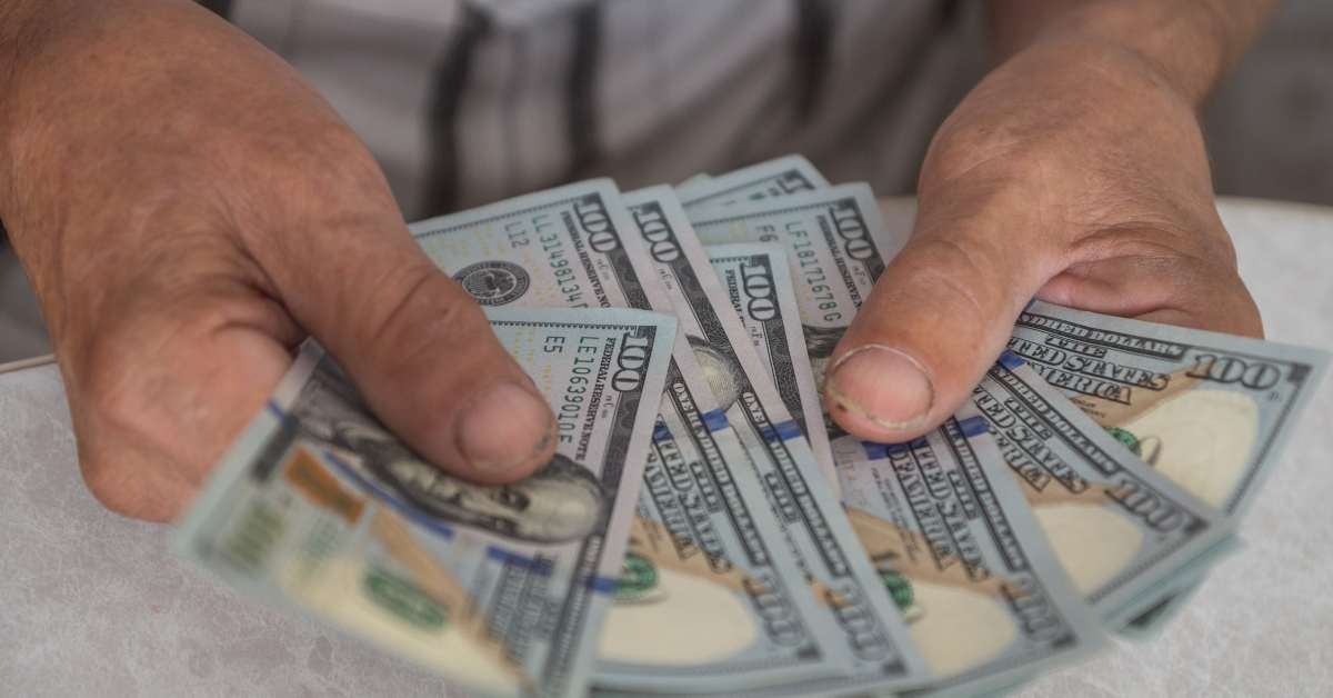 man hands holding american dollar bills