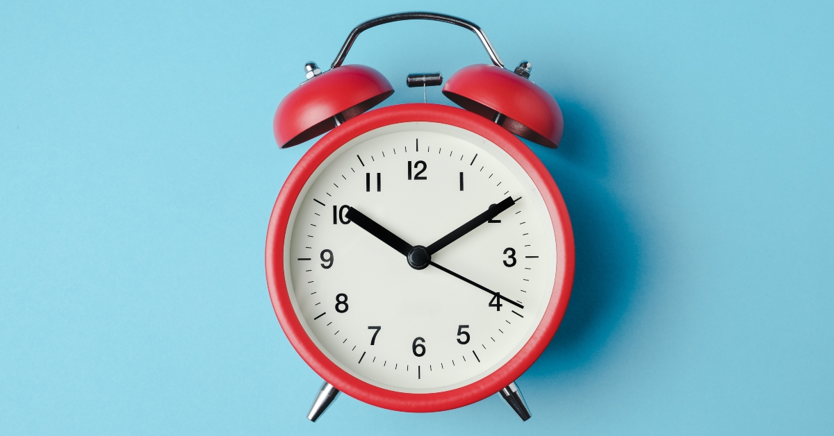 alarm clock on light blue color background