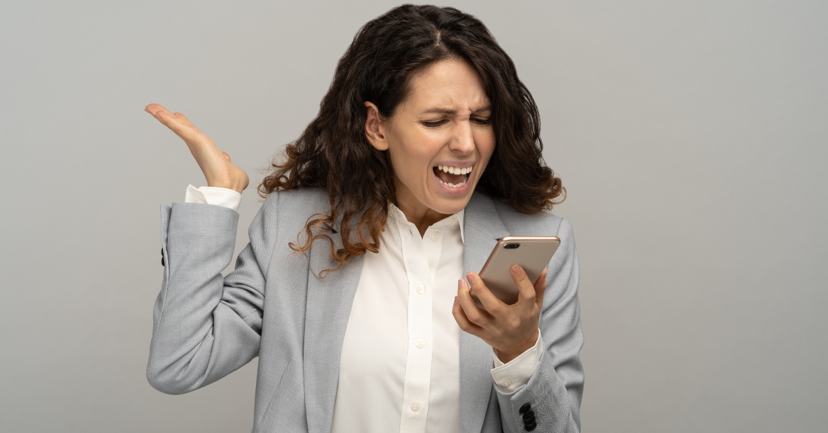 angry business woman screaming into a mobile phone