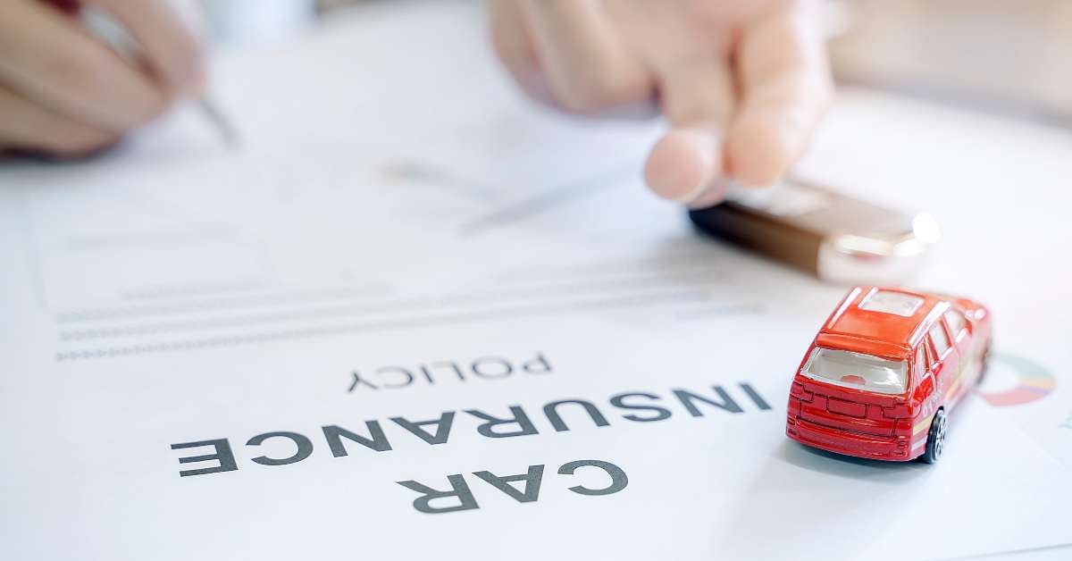 car insurance policy with red car toy