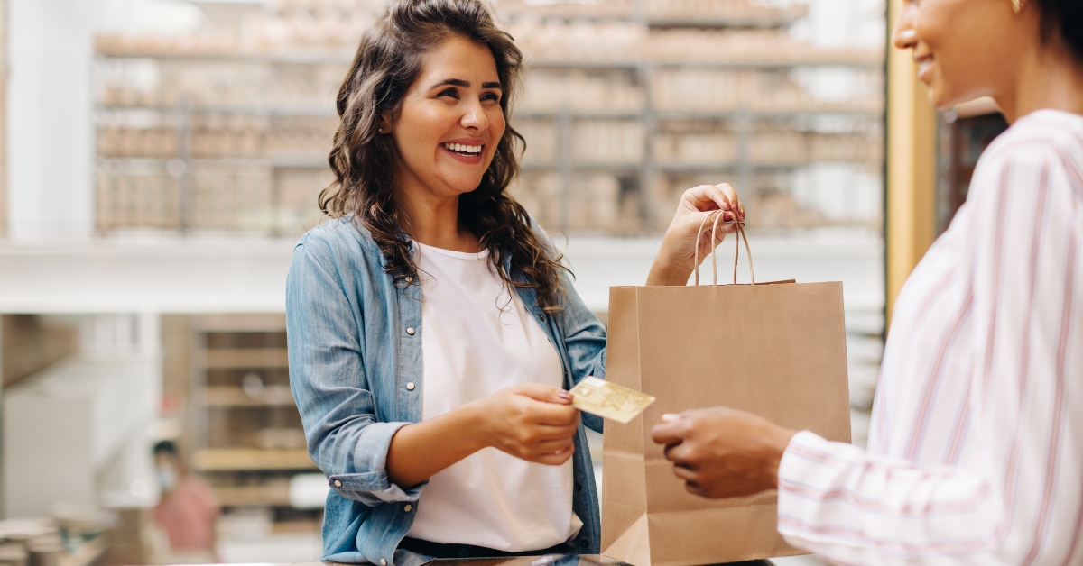 happy female customer paying with credit card