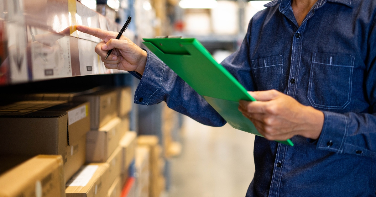 man worker doing stocktaking of product in warehouse