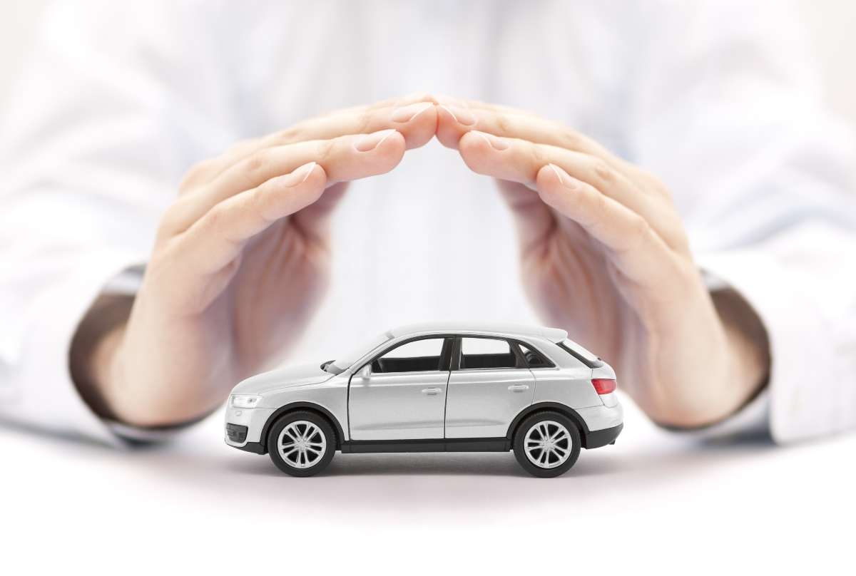 small silver car covered by hands