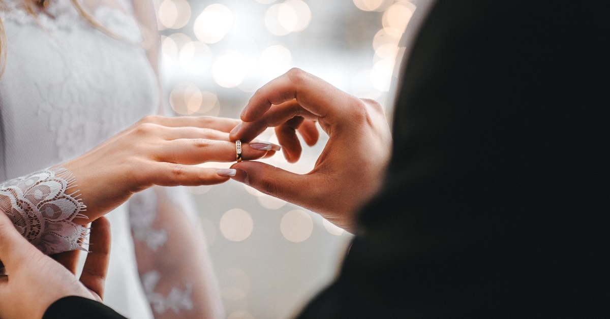 wedding rings put on a finger 
