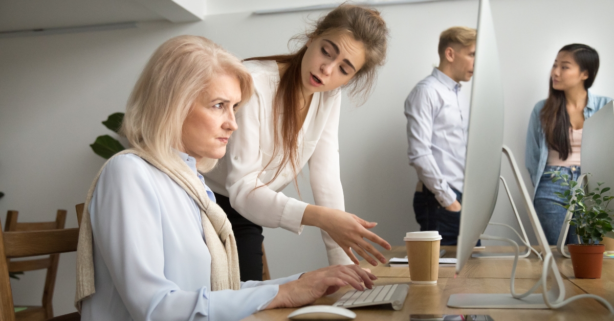 young team leader correcting offended senior employee