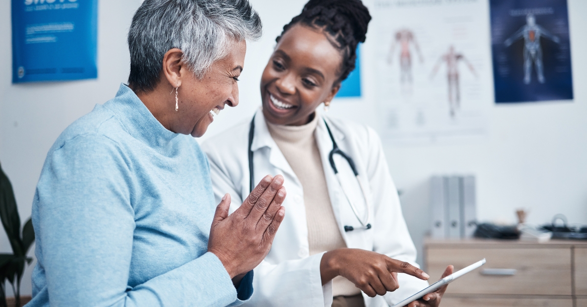 happy doctor and elderly patient with good news
