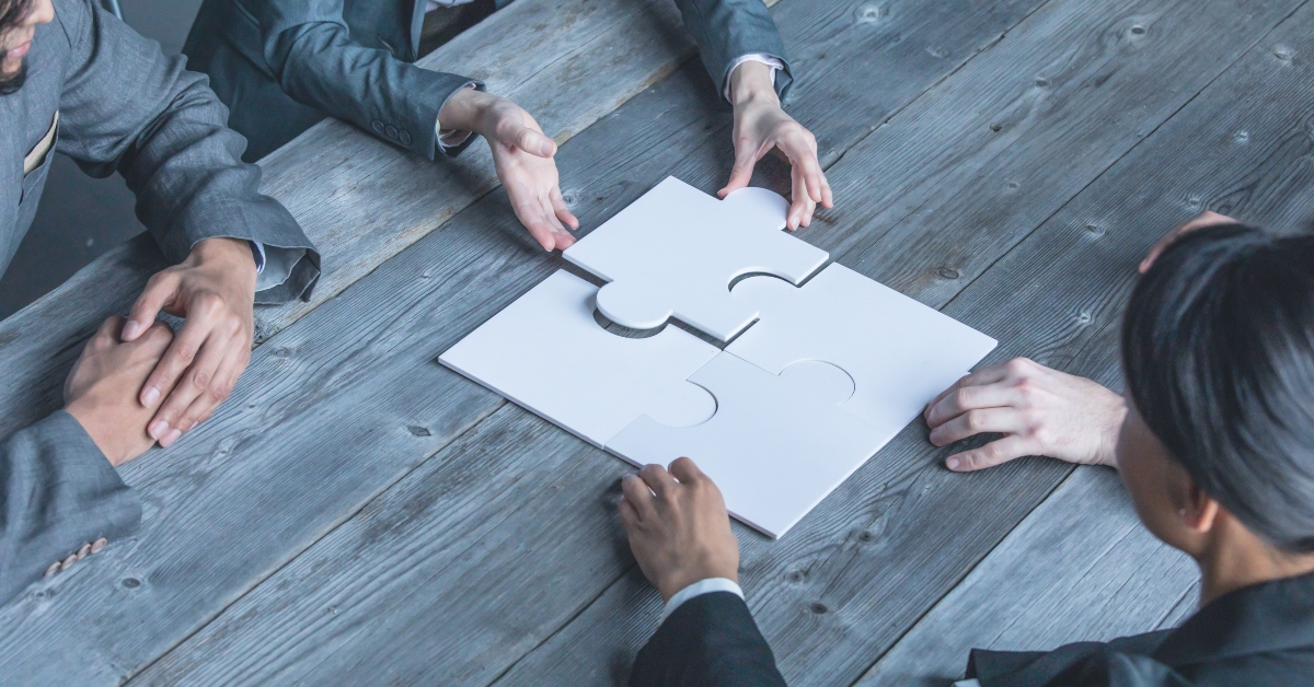 team assembling jigsaw puzzle 