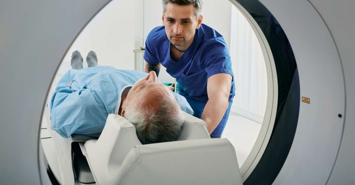 senior man going into ct scanner