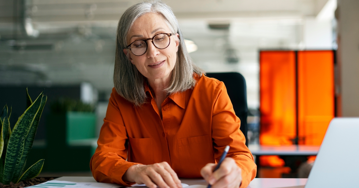 senior woman writing on notes