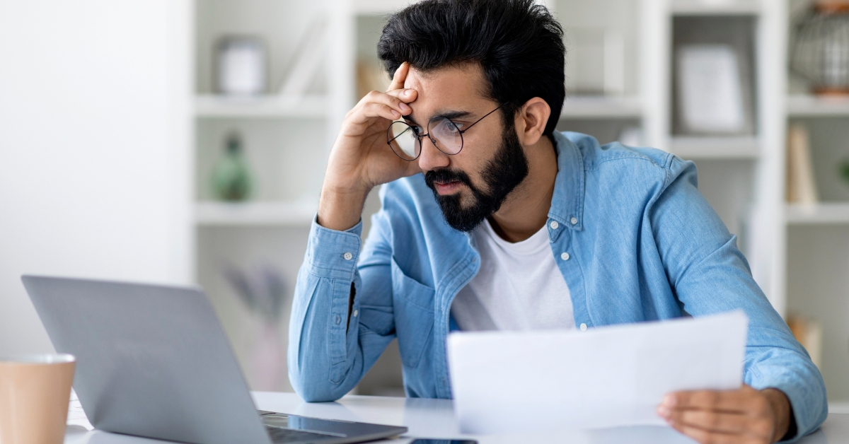 stressed young man working remotely at home