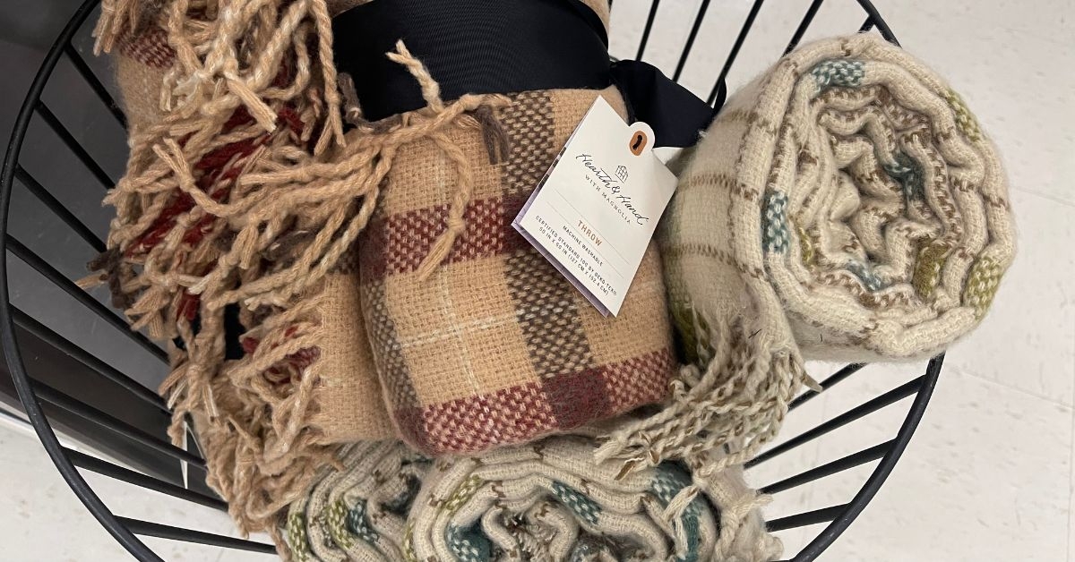 hand with magnolia throw blanket