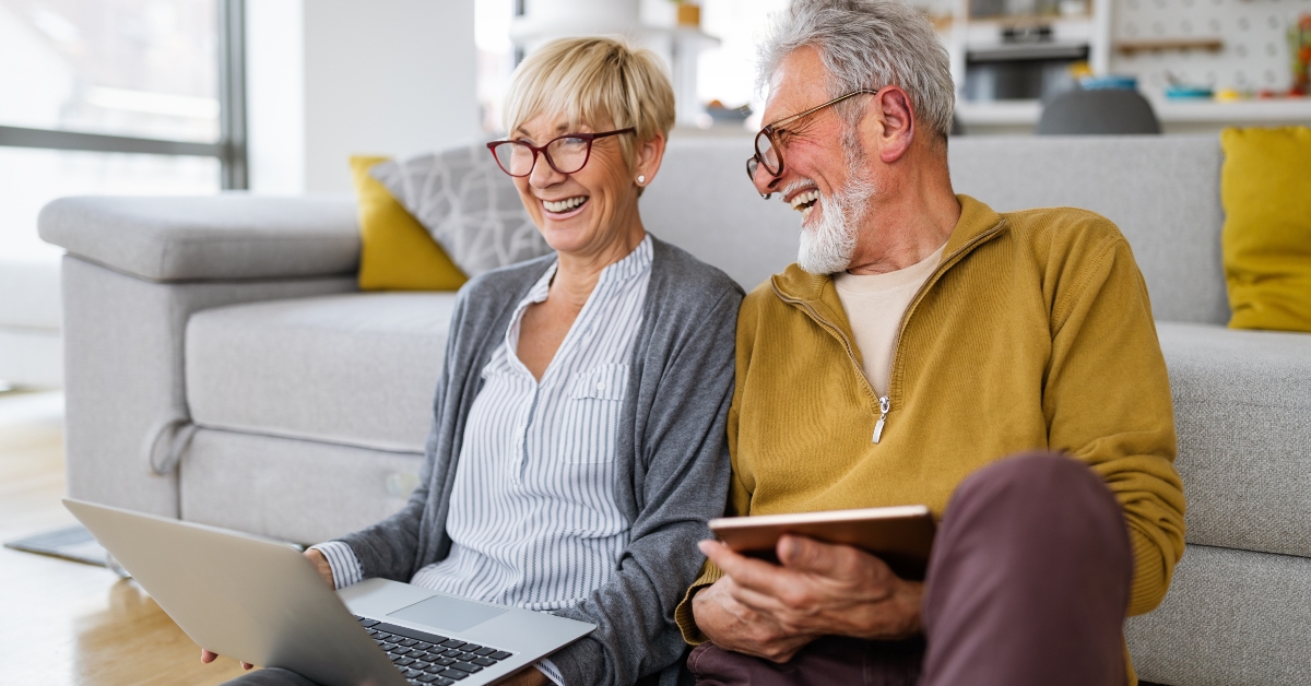 happy senior couple using laptop at home