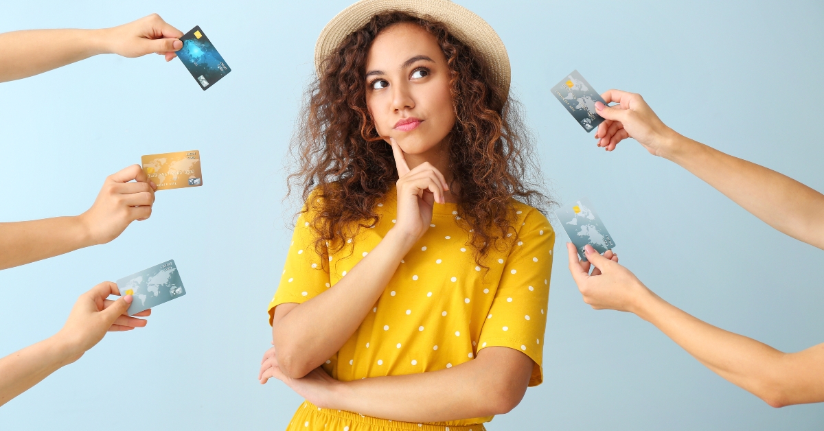 thoughtful woman with credit cards