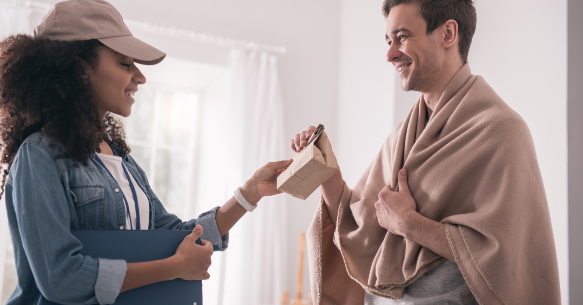 Joyful positive man looking at the delivery person