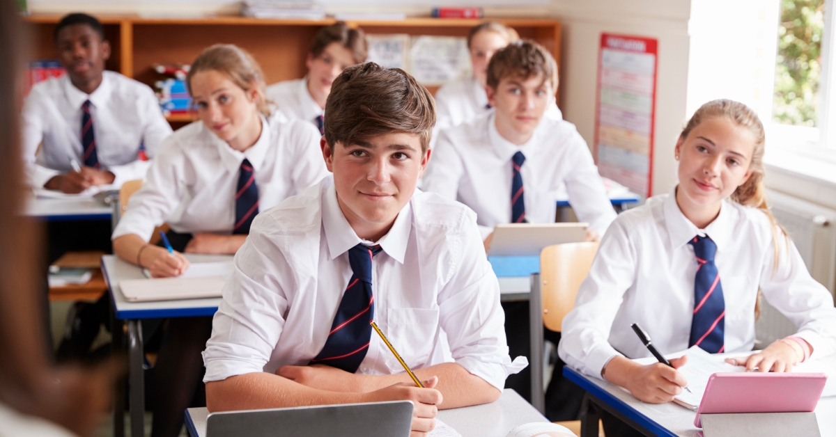 students listening to female teacher