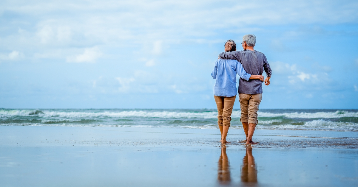 Senior couple walking on the beach