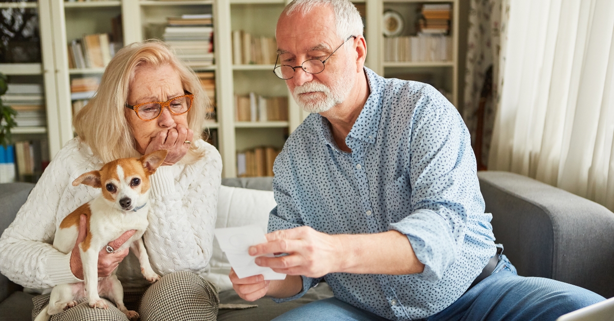 senior couple worried looking at bills
