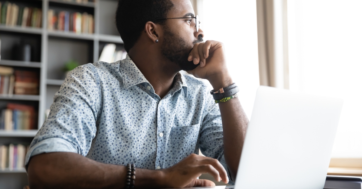 african man sit with laptop thinking of project