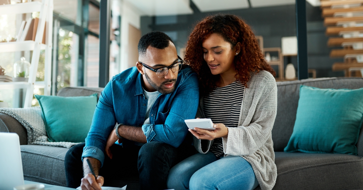 couple organizing bills for paying debt