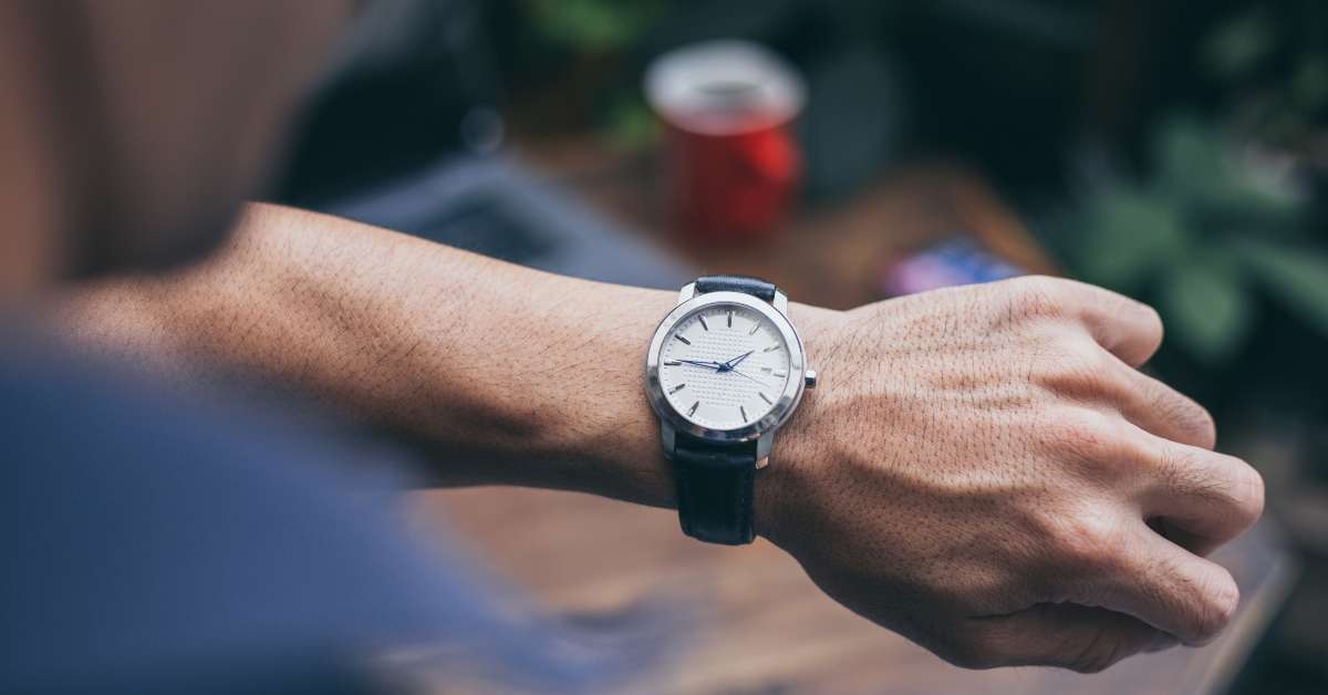 checking luxury watch to check time