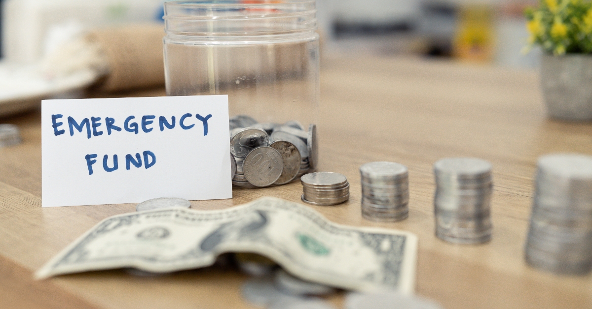 jar marked emergency fund with stacked coins