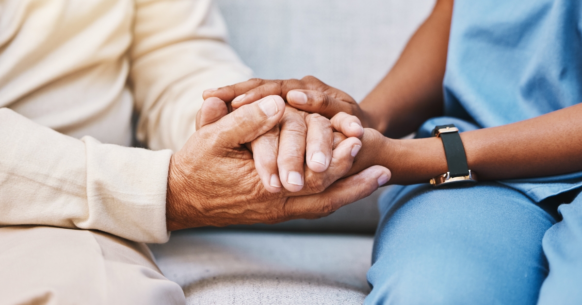 nurse holding the hands of patient