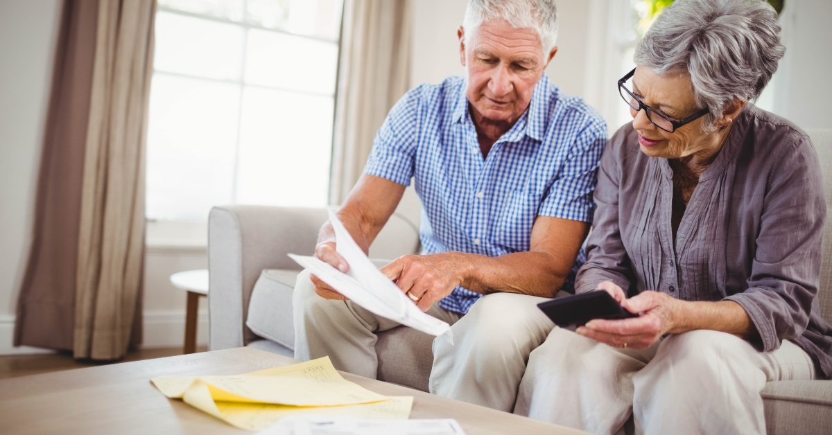 senior couple reading paper documents