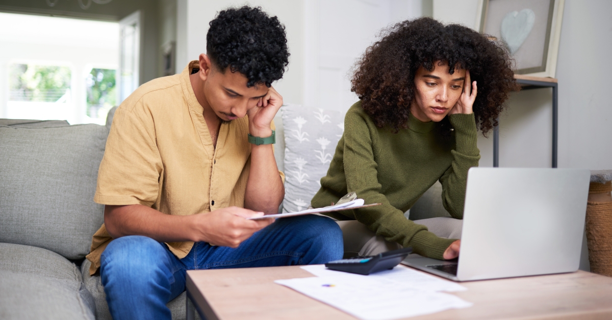 focused couple reviewing financial documents