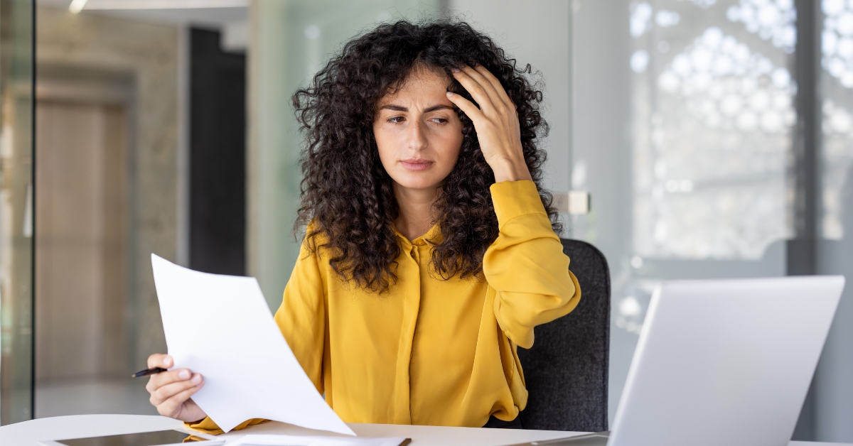 woman reviews documents in her office