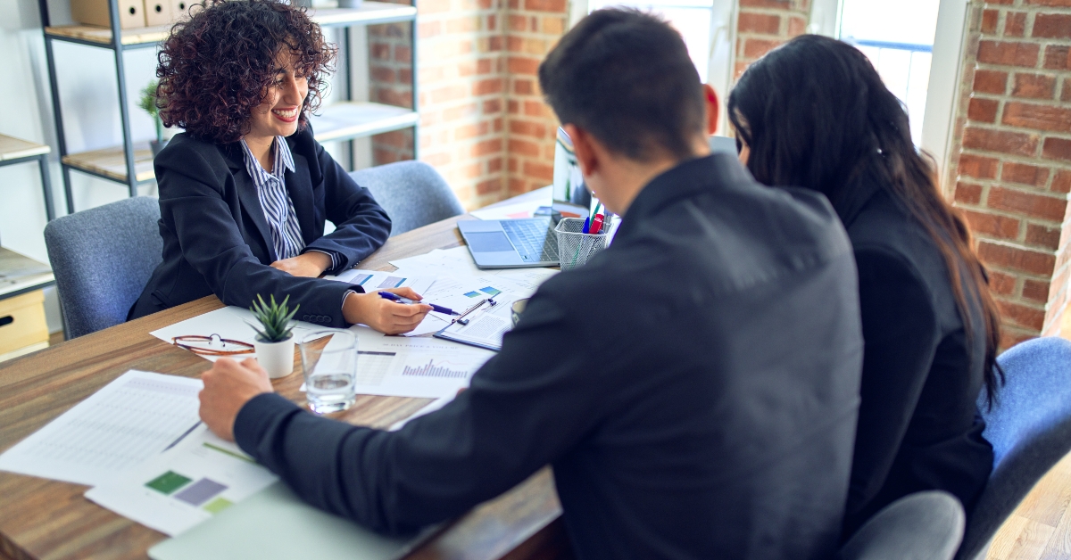 young couple having a meeting with real state agent