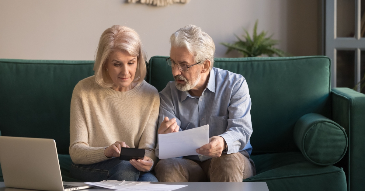 serious senior couple calculating bills