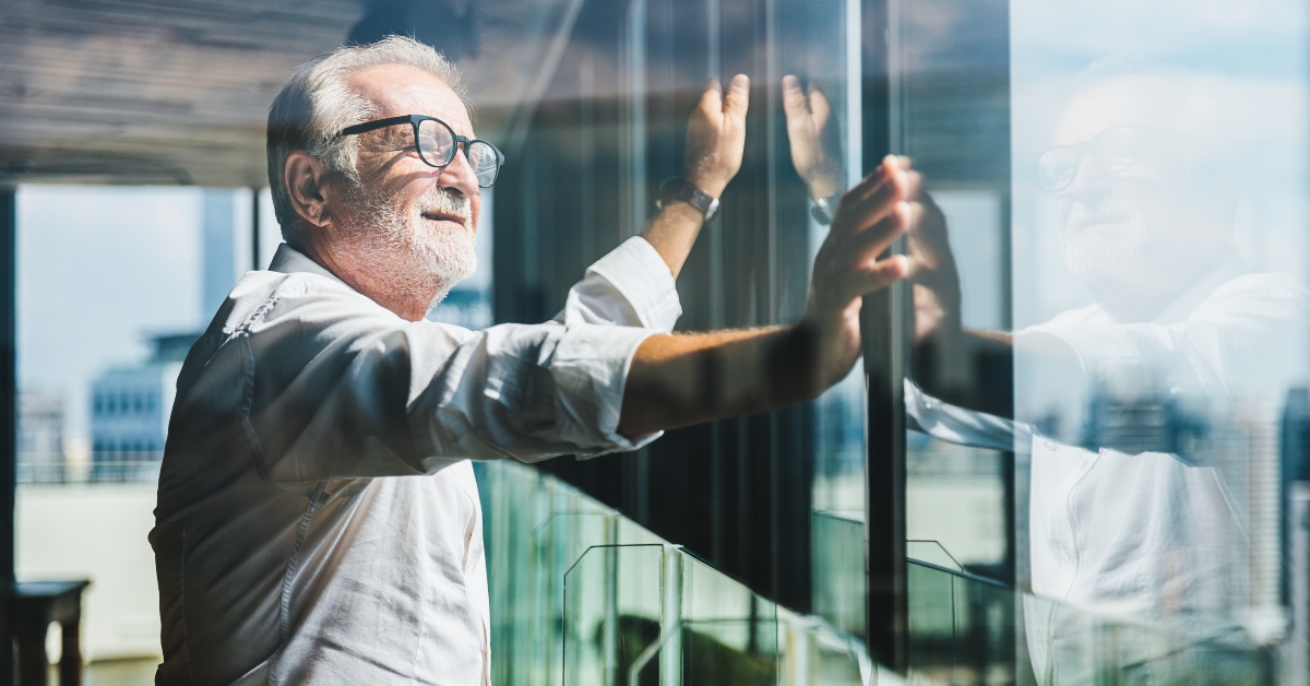 businessman standing near office window