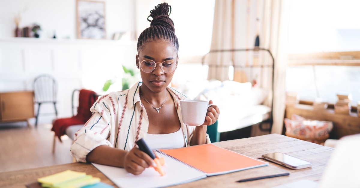 woman in striped shirt sipping coffee