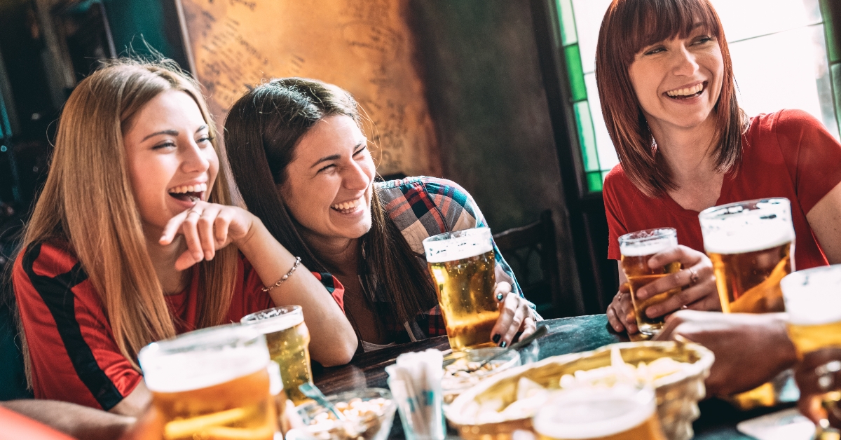 best friends drinking beer at vintage bar restaurant