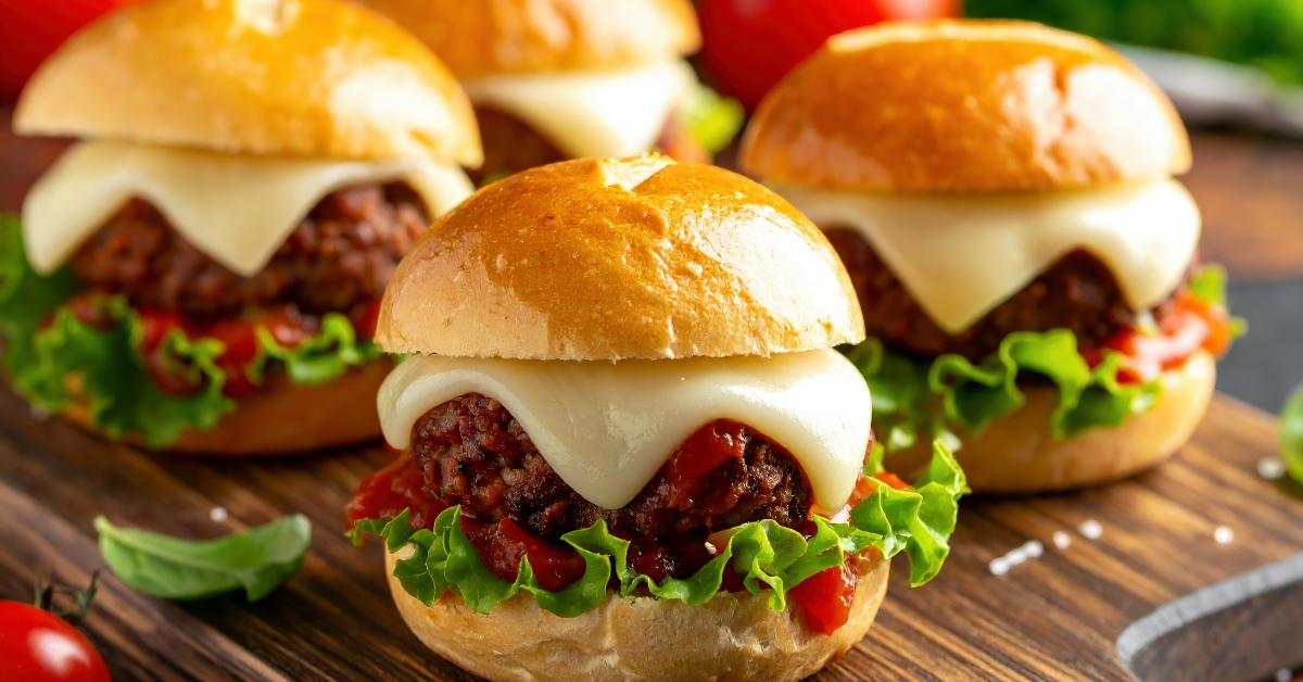 Freshly made cheeseburgers with lettuce