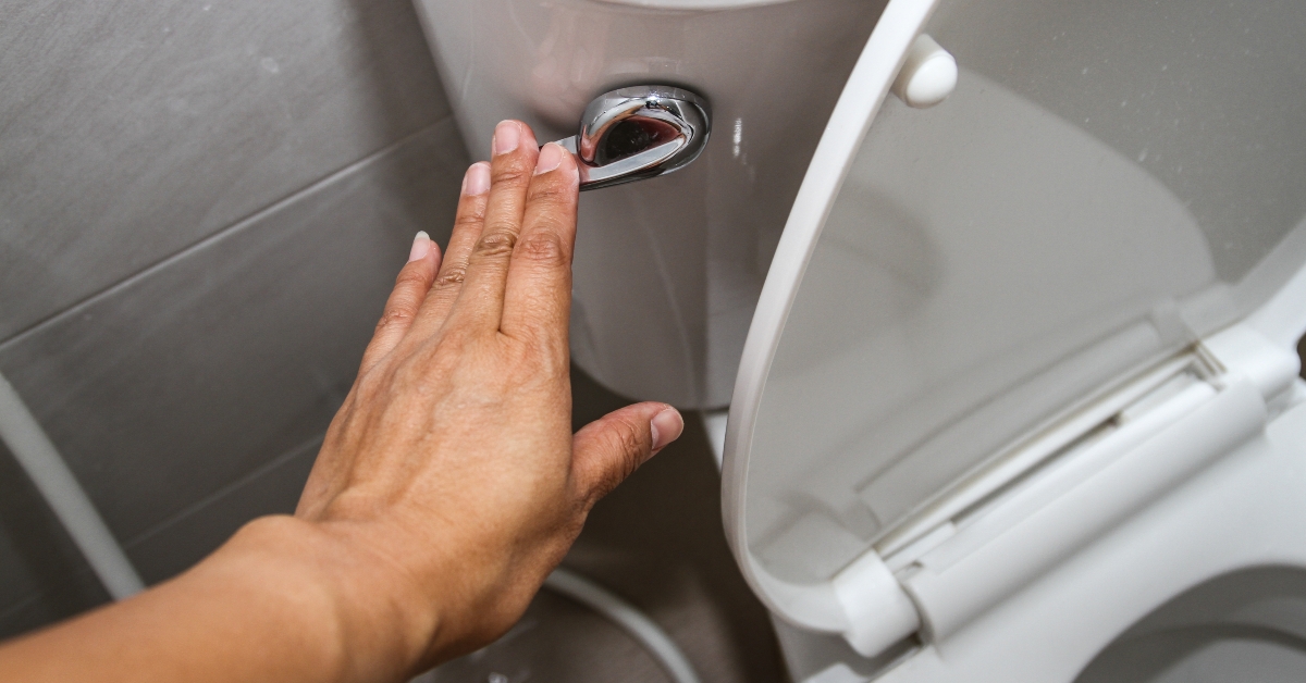 pressing a white toilet bowl 
