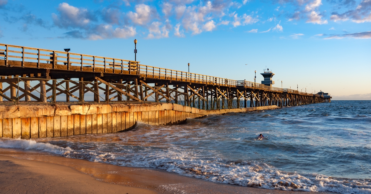 sunset light hitting seal beach pier