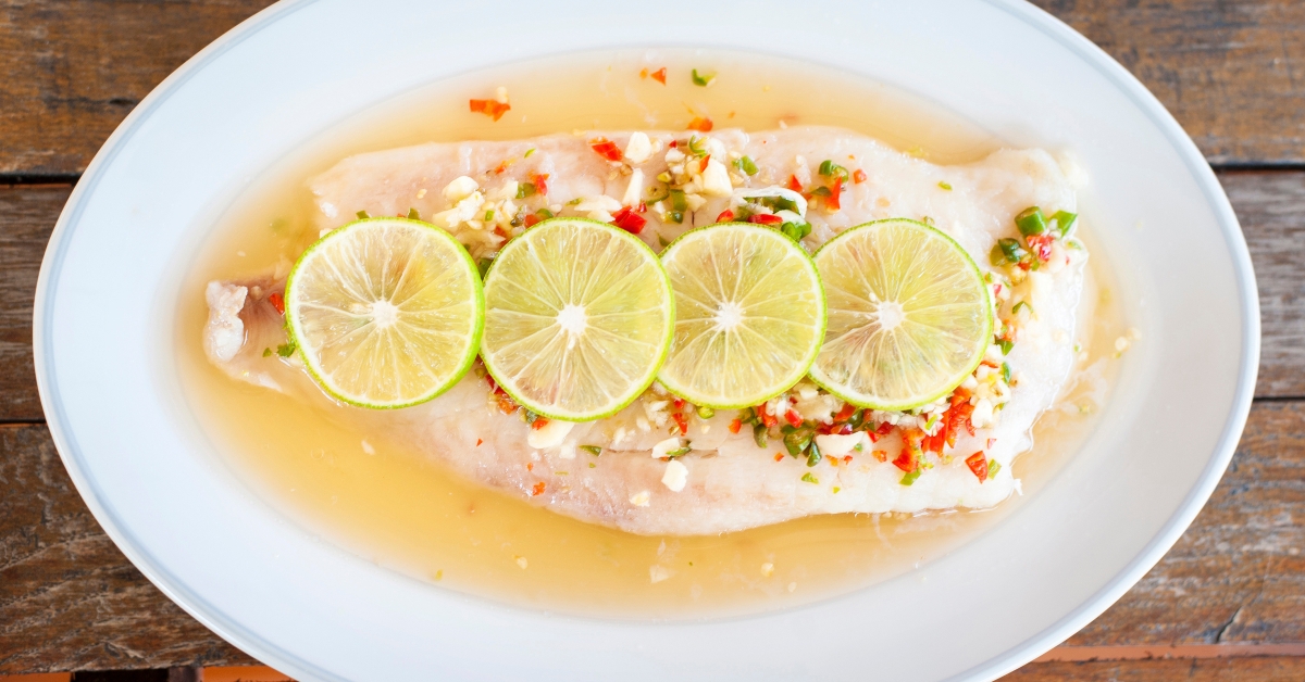 Steamed fish in lime on wooden table