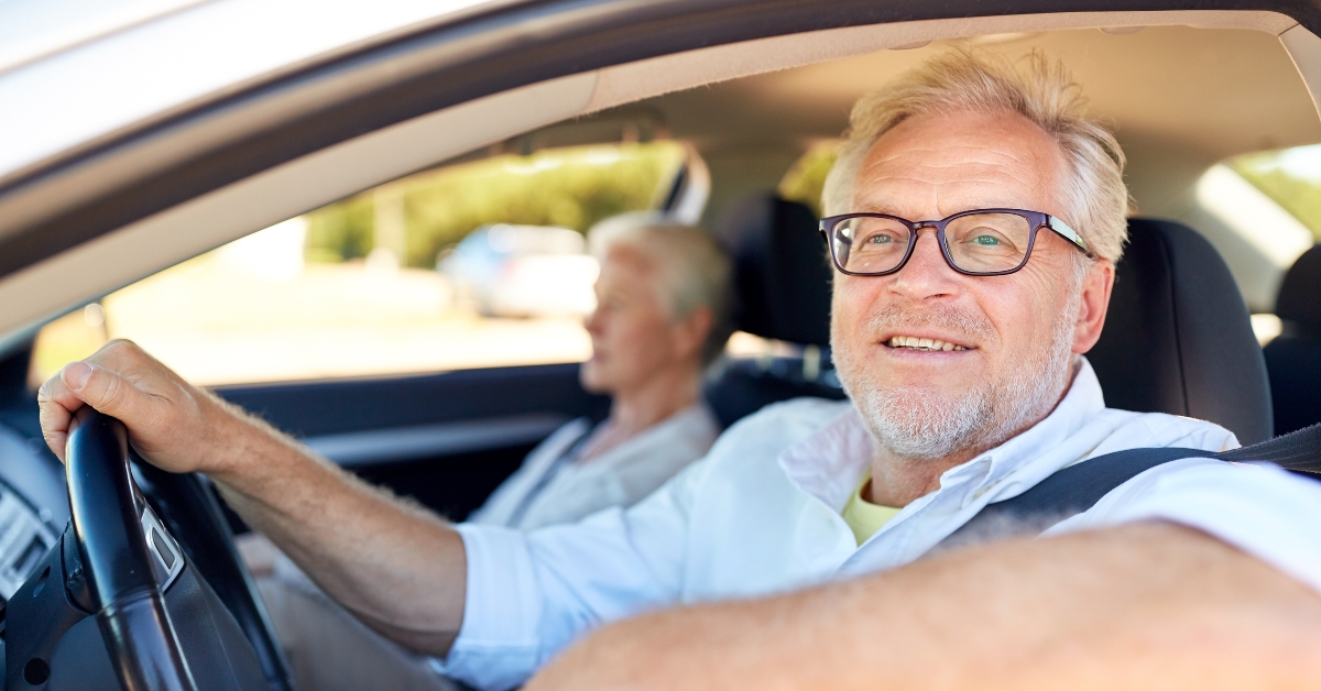 happy senior couple driving in car 