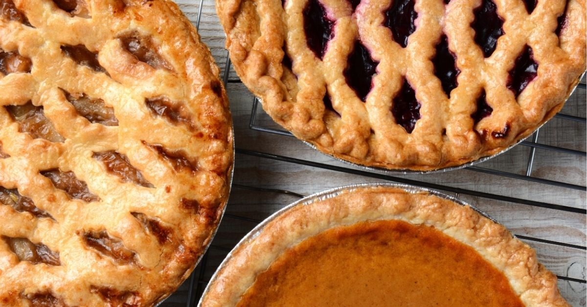 Three pies on cooling racks. 