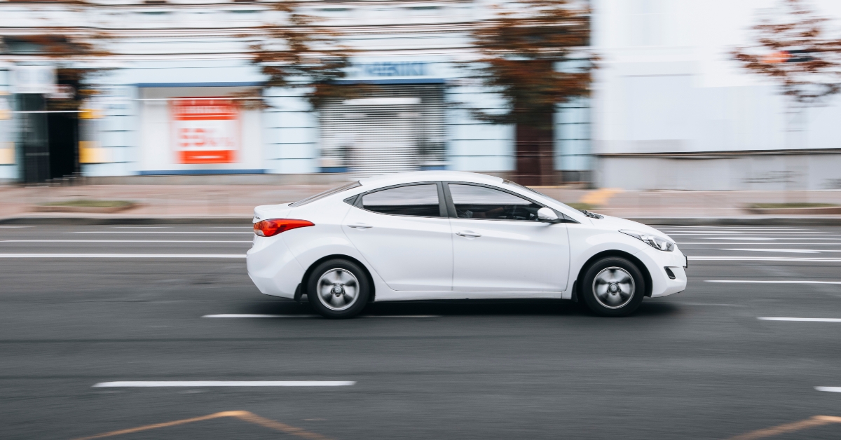 White Hyundai Elantra car moving on the street