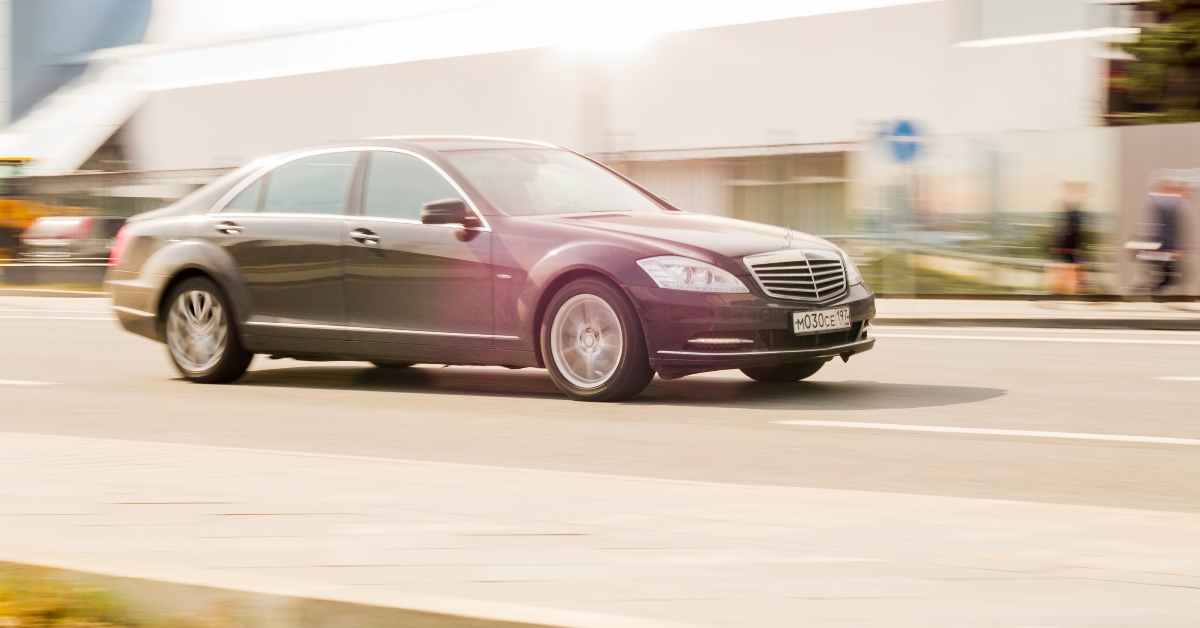 Black car driving along the street