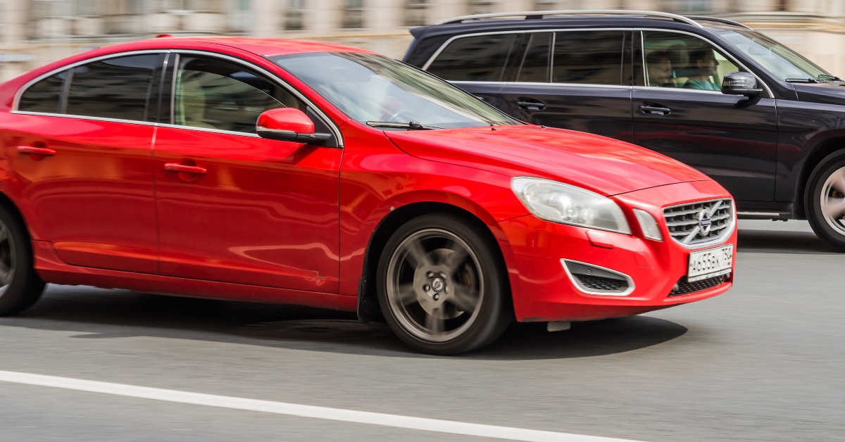 Two usual cars racing at high speed