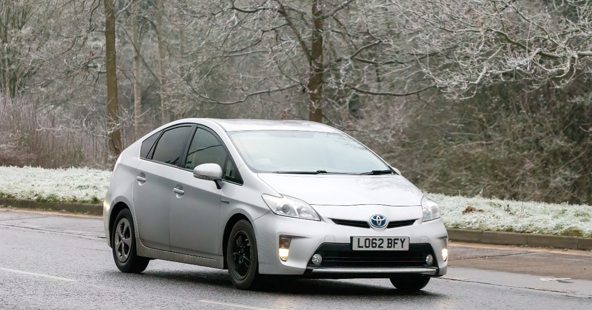 hybrid electric car driving on a cold,frosty morning 