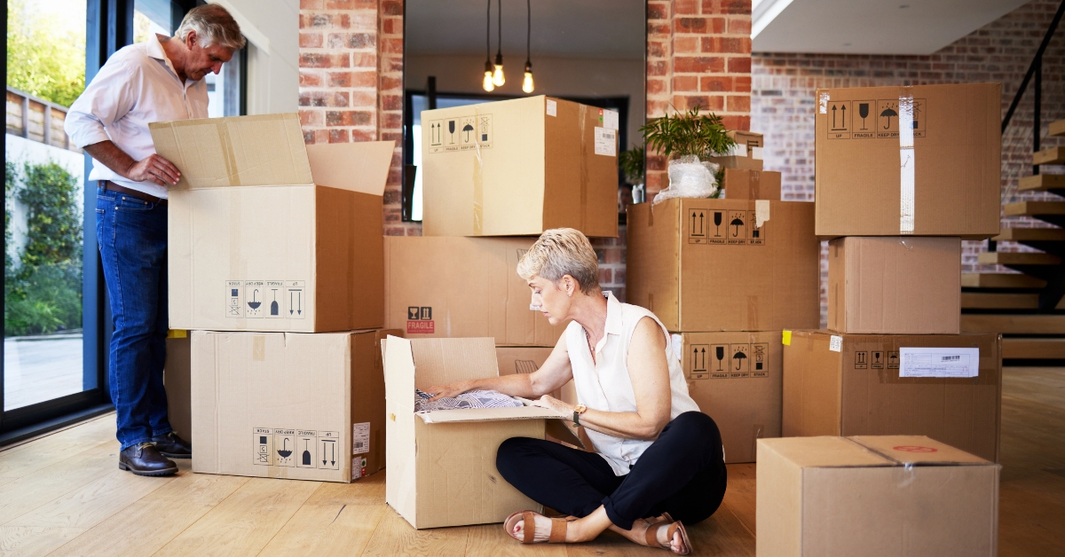 man and woman with cardboard packages