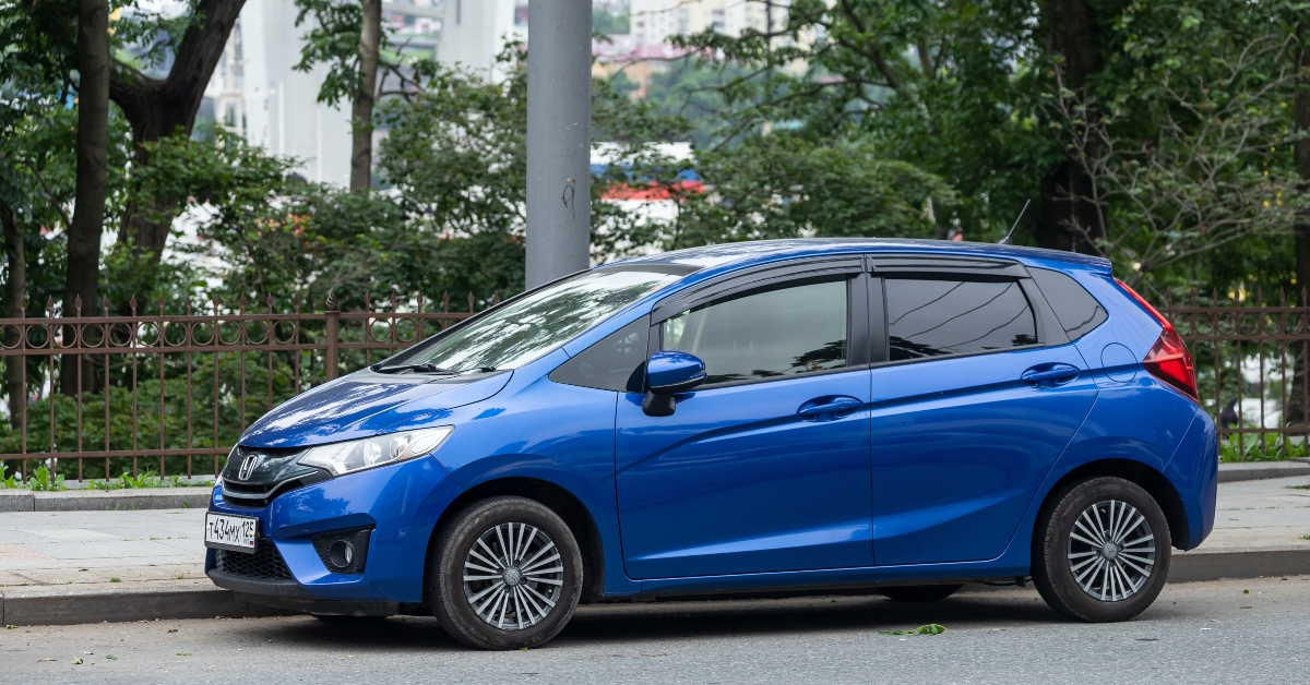 blue honda fit jazz is parked