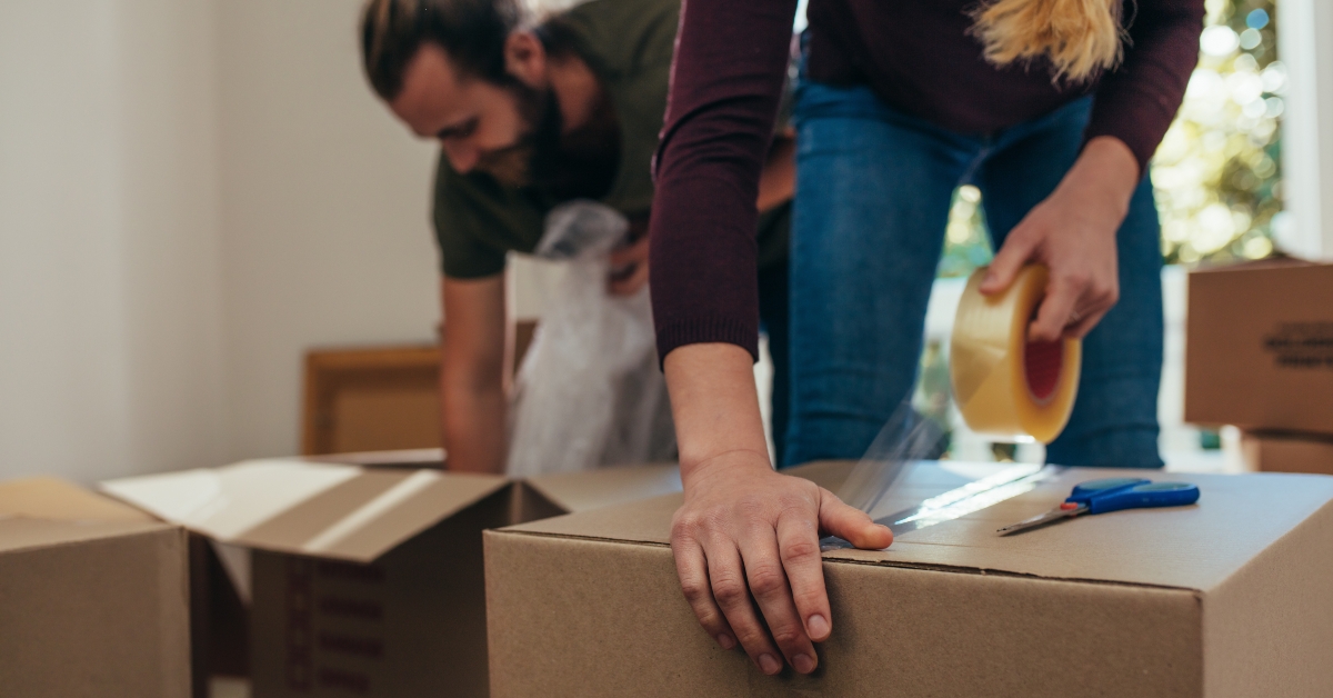 applying adhesive tape on a packing box 