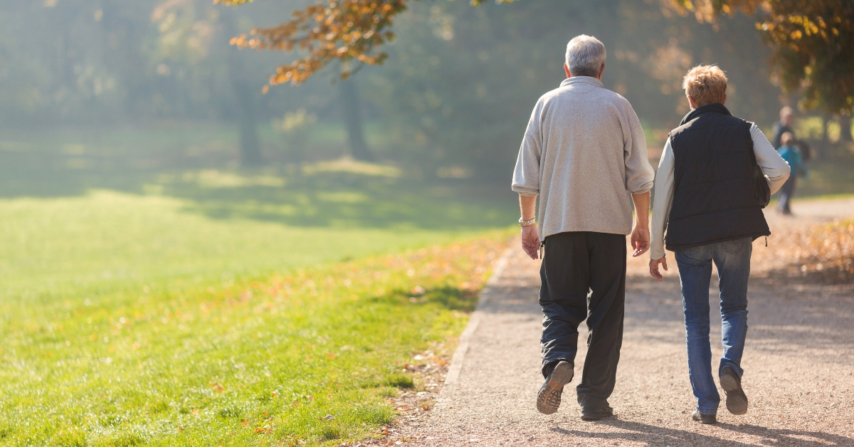 Senior citizen couple taking a walk in a park