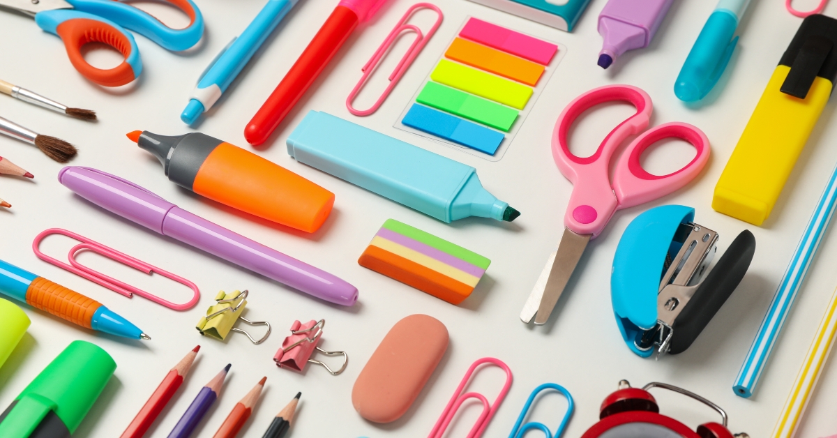 Flat lay with different school supplies on white background