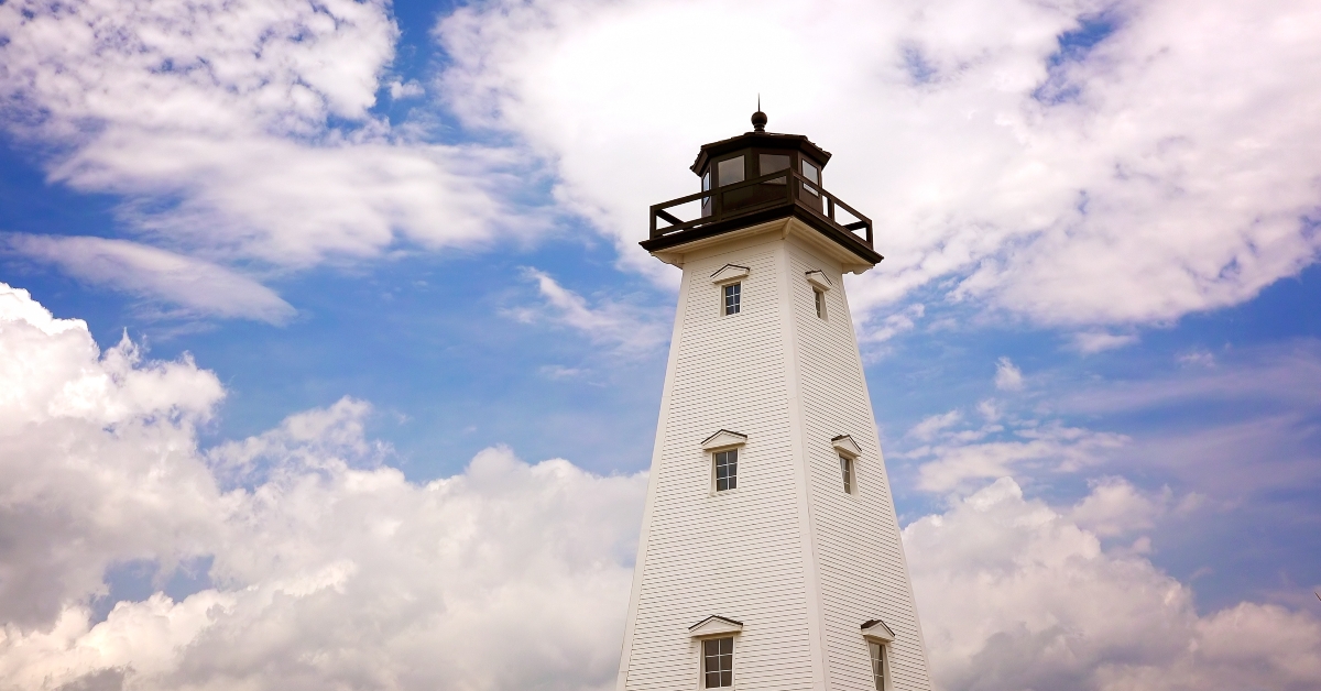 lighthouse against cloud filled sky